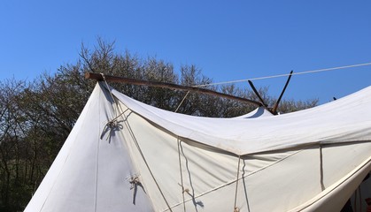 Old vikings tent made of cloth and wood in front of a blue sky