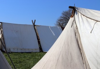 Old vikings tent made of cloth and wood in front of a blue sky