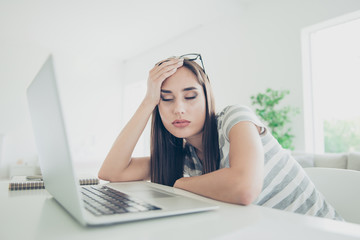 Obraz premium Close up photo beautiful she her lady notebook table sleepy eyes closed head lean arm hand sleepless night wait skype call wear jeans denim striped t-shirt sit comfort chair house living room indoors