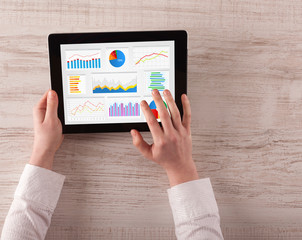 Hand making diagrams and charts on tablet
