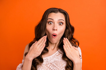 Close-up portrait of her she nice attractive lovely charming cute pretty fascinating confused wavy-haired lady showing amazement isolated over bright vivid shine orange background