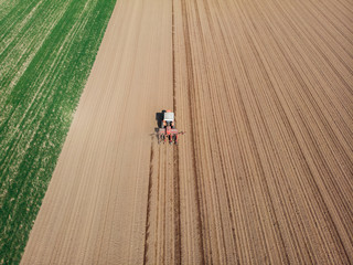 Aerial view of a tractor plowing the fields, aerial view, plowing, sowing, harvest. Agriculture and Farming, campaign. Desert and dehydrated lands, global warming