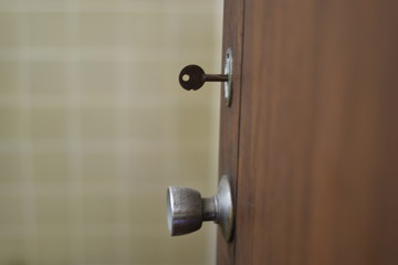Old handle stainless steel door on Brown wooden doors, silver color of door handle.