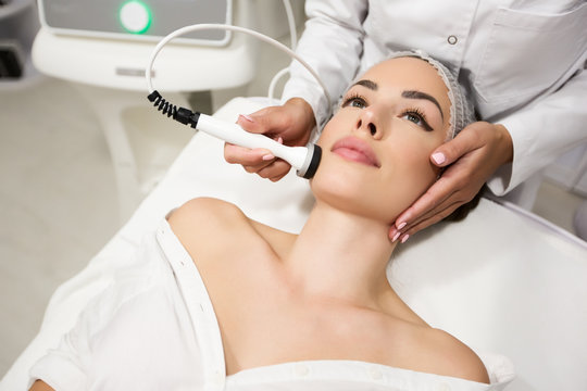 Beautiful woman in professional beauty salon during photo rejuvenation procedure