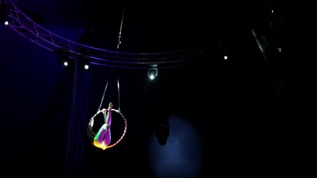 Langhorne, PA / United States - April 18, 2019: Wide circus performer woman hanging from ring close up