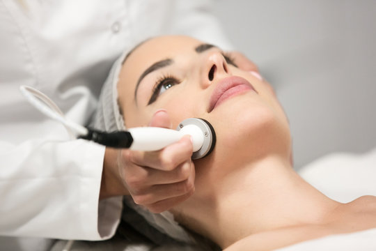 Beautiful woman in professional beauty salon during photo rejuvenation procedure