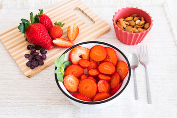 Healthy snack for diet with fresh fruit like strawberry, almonds and berries. Healthy eating