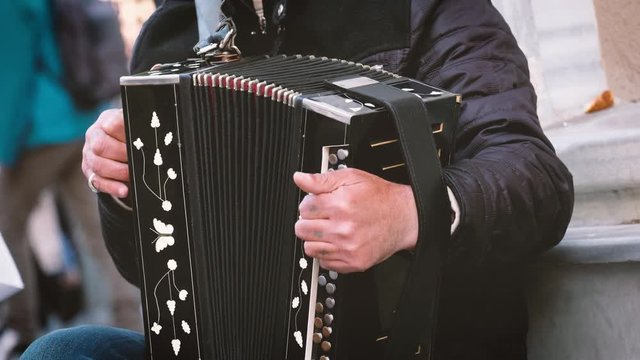 Close Up Shot Of Male Hands Playing Accordion