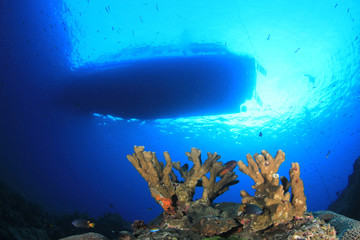 Scuba diving boat above coral reef 