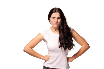 Angry girl standing with hands on waist and looking at camera