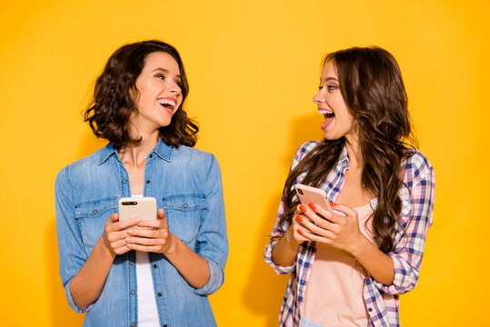 Portrait of cute funny funky fellows fellowship use user device apps social media account read news laugh impressed enjoy true smm news feed open mouth ioslated checked jeans shirt yellow background