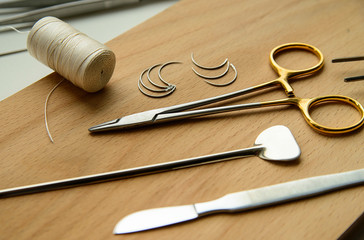 surgeon's tools on wooden background