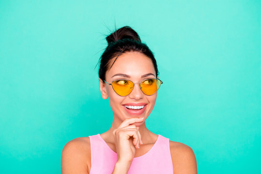 Close up photo beautiful amazing she her lady funny trendy hairstyle hand arm chin look empty space toothy wondered wear sun specs casual pink tank-top clothes isolated teal turquoise background