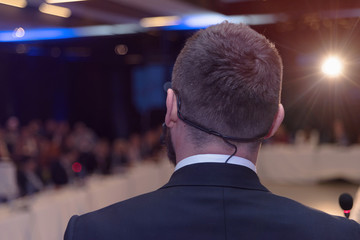 Young businessman at business conference room with public giving presentations. Audience at the conference hall. Entrepreneurship club.