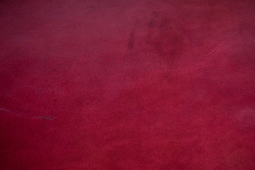 Abstract background of genuine red cartier leather