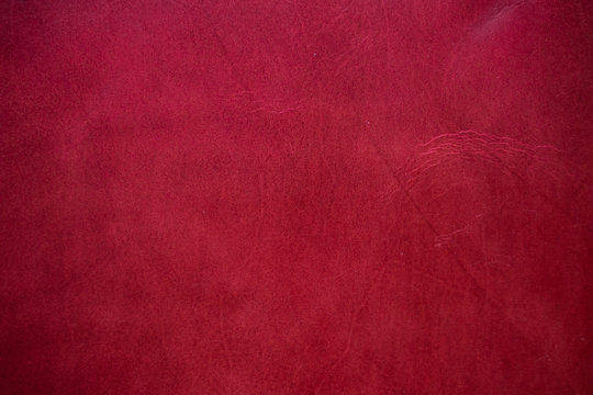 Abstract background of genuine red cartier leather