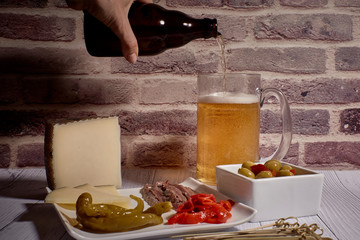 cheese board next to a beer