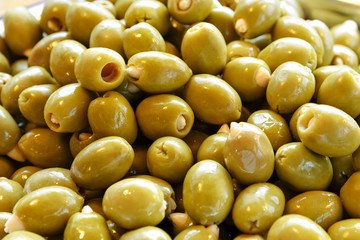 Closeup of fresh healthy green olives for sale at the farmers market.
