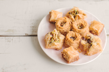 Assorted baklava on wooden table. Traditional arabic dessert