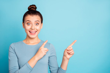 Close up photo beautiful funny she her lady arms hands fingers indicate empty space amazed proposition advising buy buyer best low price wear casual sweater pullover isolated blue bright background