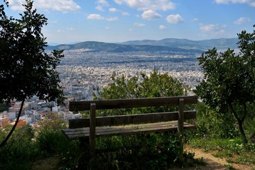 bench on the mountain overlooking the big city