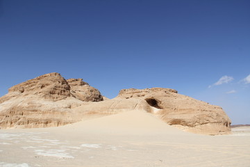 Fototapeta na wymiar Blue sky in the mountain yellow desert on the background of the Dragon Mountain