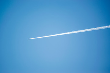 High-altitude plane with smoke trail