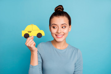 Portrait of nice charming beautiful top-knot lady hold hand paper car yellow taxi cab look show...