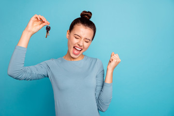 Fototapeta Portrait of delighted lady luck lucky triumph raise fists close eyes content rejoice scream shout yeah mover move in settlement loan beautiful bun trendy stylish sweater isolated on blue background obraz