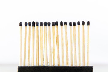 row of wooden matches ready to burn together