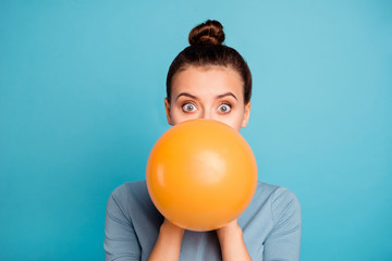 Close up photo of astonished funky teen teenager impressed omg wow unbelievable unexpected incredible wonder hide orange ballon hold hand wear modern pretty clothing isolated on blue background