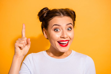 Close-up portrait of her she nice attractive lovely winsome creative genius cheerful girl pointing finger up ad advert good recommend new isolated over bright vivid shine yellow background