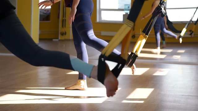 Women Training with Resistance Bands in a Gym