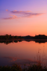 Pastoral decor in pastel colors. Sweet landscape with reflection of the sky in the sea at sunrise