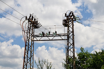 Electricity high voltage pole and the blue and cloudy sky