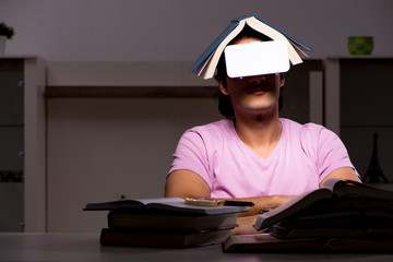 Male student with virtual glasses late at home 