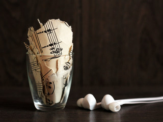 Ragged notes in the glass and white headphones