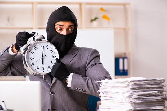 Male gangster stealing information from the office 