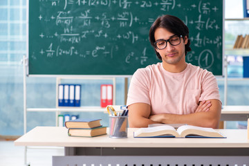 Young male student in the classroom 