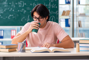 Young male student in the classroom 
