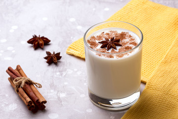 Glass of eggnog and candy cane.