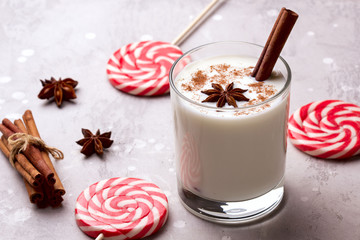 Glass of eggnog and candy cane.