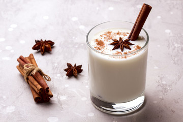 Glass of eggnog and candy cane.