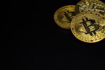 Golden Bitcoin on a black background, money