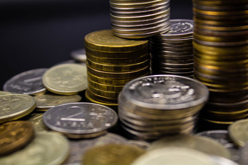 Coins stack on black background in concept wall and strong money.