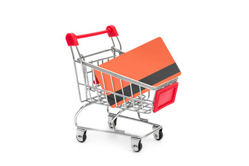 Shopping cart with credit card on white background.