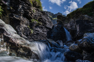 Naklejka na ściany i meble Waterfall in the Swiss mountains