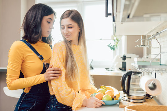 nice beautiful girls in stylish clothes talking in the kitchen. close up photo.friendhip concept. free time, spare time. weekend