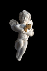 Valentine's Day, Christmas: Antique statuette of a white angel with a cross in his hands, isolated on black