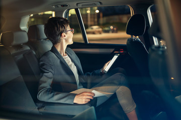 business woman traveling with car by night on business trip.